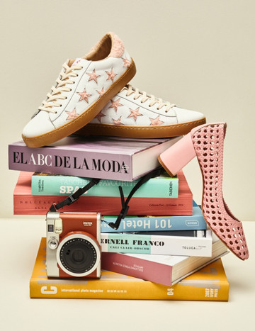 Zapatos sobre libros Zapatos sobre libros de moda, un zapato de tacón cayéndose y una cámara de fotos antigua